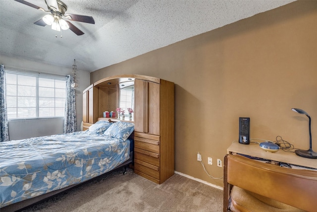 carpeted bedroom with multiple windows, ceiling fan, a textured ceiling, and baseboards