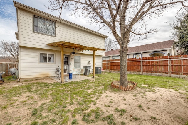 back of house featuring a yard, a patio, central AC unit, a ceiling fan, and a fenced backyard