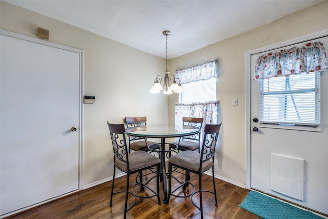 dining room featuring baseboards, a chandelier, and wood finished floors