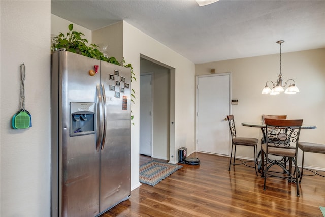 kitchen featuring stainless steel fridge, baseboards, a chandelier, and wood finished floors