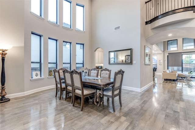 dining room with light wood-style flooring, visible vents, and baseboards