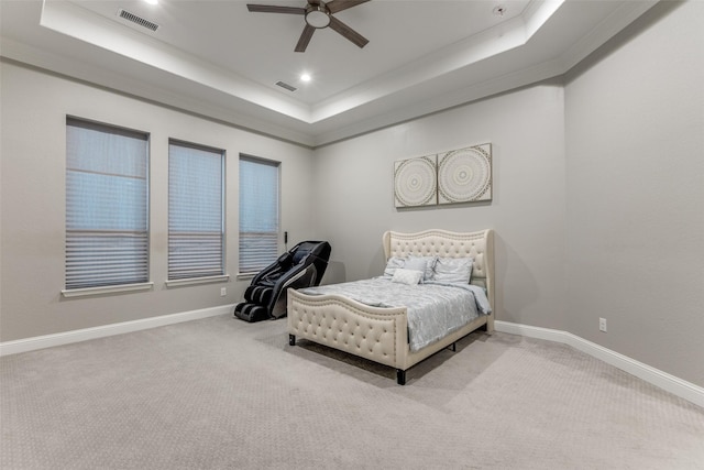 bedroom with carpet, a raised ceiling, visible vents, and baseboards