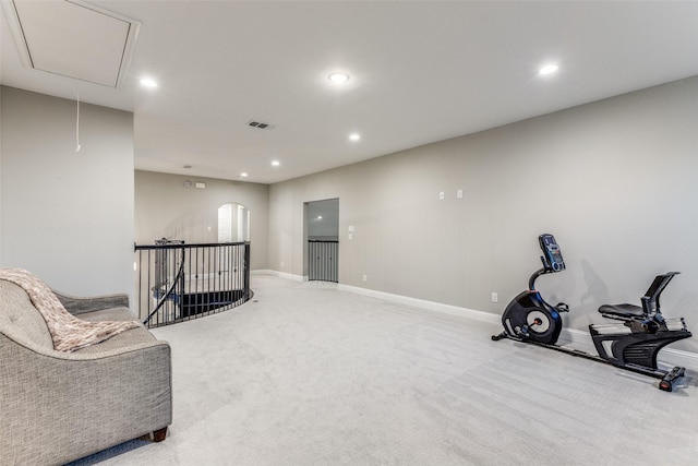 sitting room with recessed lighting, light colored carpet, visible vents, attic access, and an upstairs landing