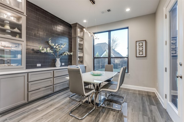 dining room featuring recessed lighting, wood finished floors, visible vents, and baseboards