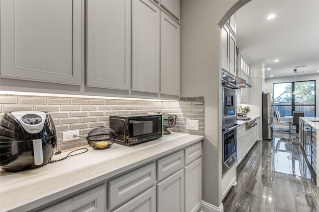 kitchen with a toaster, tasteful backsplash, recessed lighting, light countertops, and white cabinetry