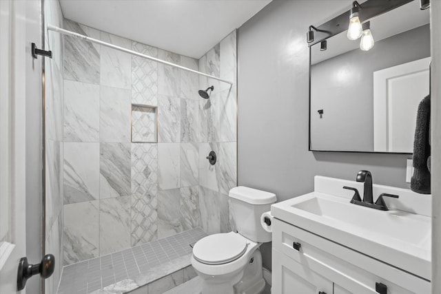 full bathroom with a stall shower, vanity, and toilet