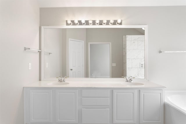 full bathroom featuring a garden tub, double vanity, and a sink