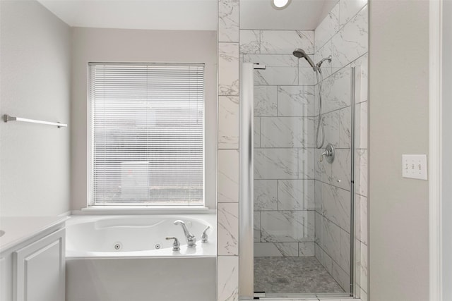 bathroom featuring a stall shower and a whirlpool tub