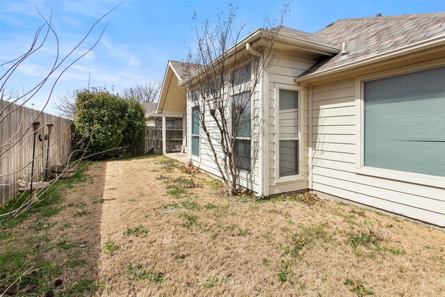 view of property exterior featuring a lawn and a fenced backyard