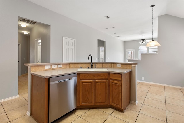 kitchen featuring a center island with sink, light countertops, visible vents, stainless steel dishwasher, and a sink