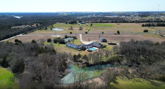 drone / aerial view featuring a water view and a rural view