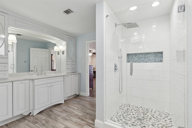 ensuite bathroom with visible vents, vanity, a stall shower, recessed lighting, and ensuite bath