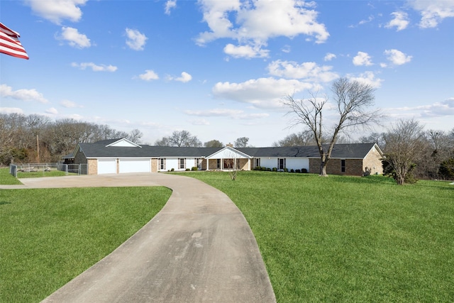 ranch-style home with brick siding, a garage, a porch, a front yard, and concrete driveway