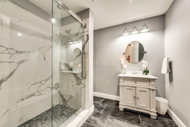 full bath with baseboards, marble finish floor, and a marble finish shower