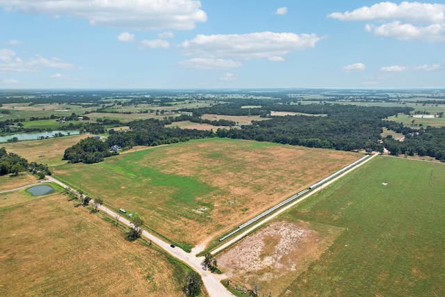 drone / aerial view featuring a rural view and a water view