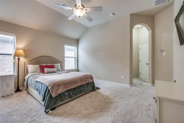 carpeted bedroom with a ceiling fan, visible vents, baseboards, lofted ceiling, and arched walkways