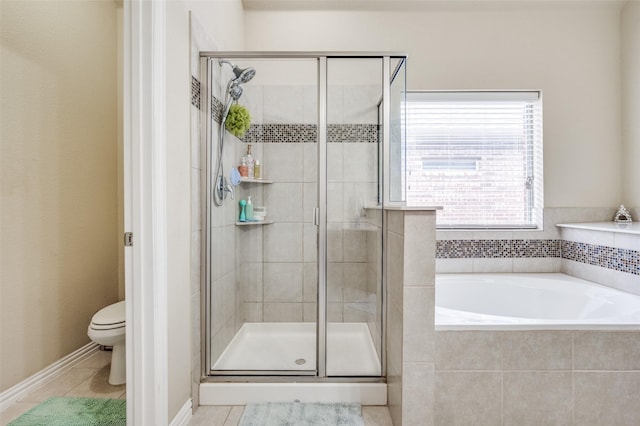 bathroom featuring toilet, a bath, a stall shower, and tile patterned flooring