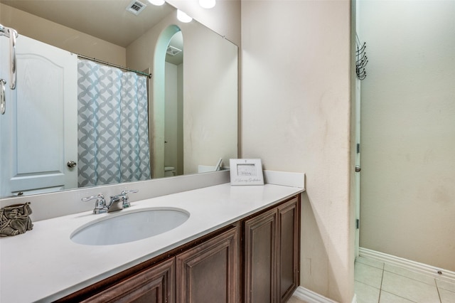 full bath featuring vanity, tile patterned floors, baseboards, and visible vents