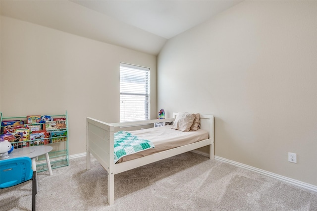 bedroom featuring vaulted ceiling, carpet, and baseboards