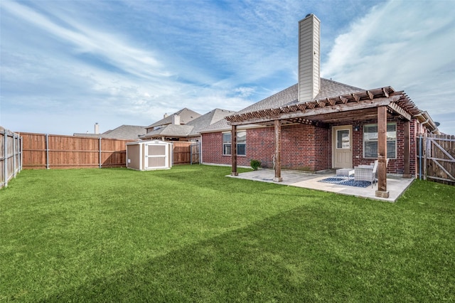 rear view of house with an outbuilding, a yard, a fenced backyard, a chimney, and a patio area