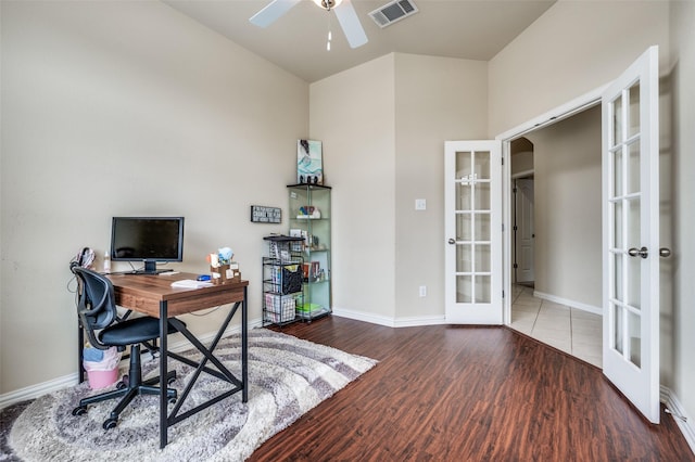 home office with visible vents, wood finished floors, french doors, arched walkways, and baseboards