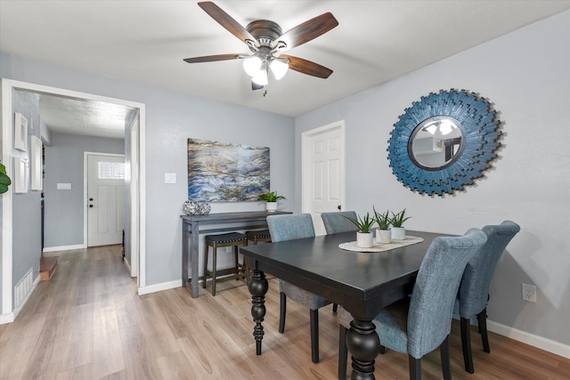 dining area featuring visible vents, baseboards, and light wood-style floors