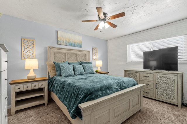 bedroom featuring ceiling fan and light carpet