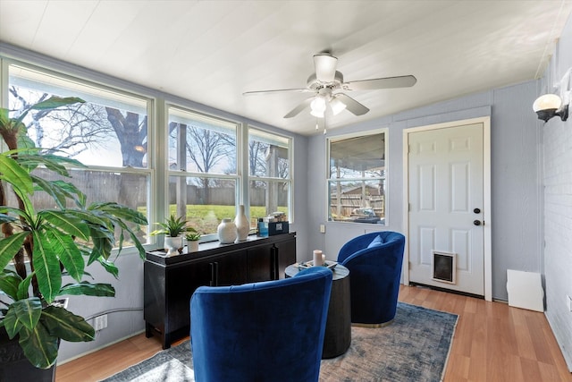 sunroom featuring a ceiling fan