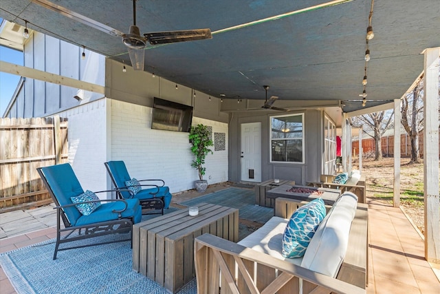 view of patio / terrace featuring an outdoor living space with a fire pit, a ceiling fan, and fence