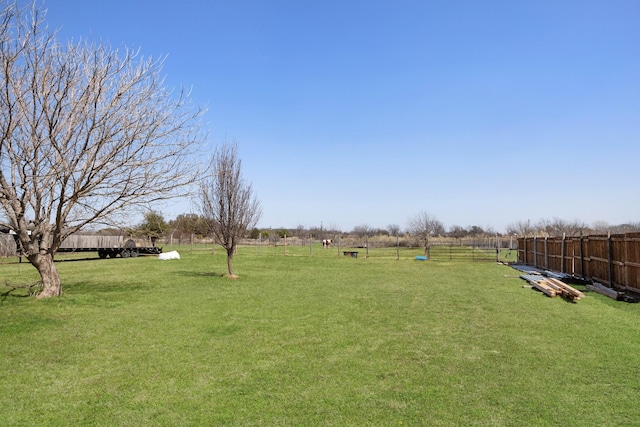 view of yard with a rural view and fence