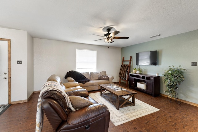 living room with visible vents, ceiling fan, a textured ceiling, wood finished floors, and baseboards