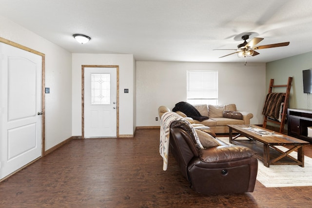 living area featuring wood finished floors, a ceiling fan, and baseboards