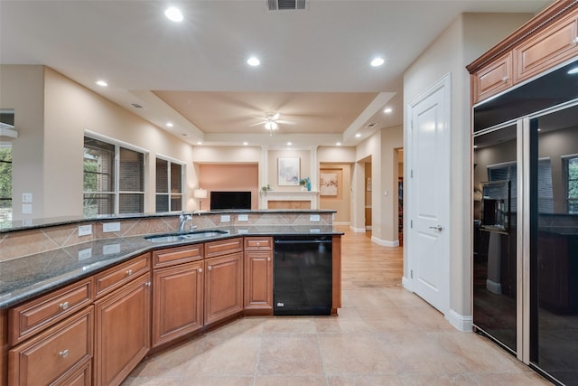 kitchen featuring open floor plan, brown cabinets, black appliances, a sink, and recessed lighting