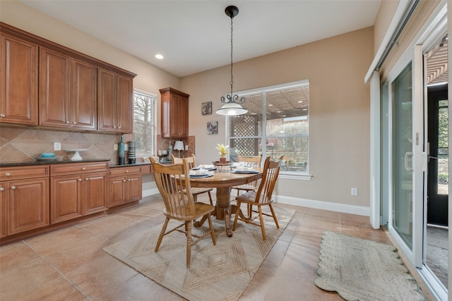 dining space with recessed lighting, baseboards, and light tile patterned flooring