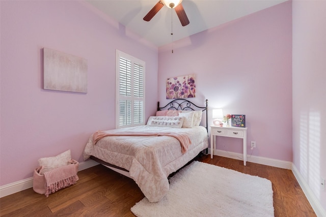 bedroom with wood finished floors, a ceiling fan, and baseboards