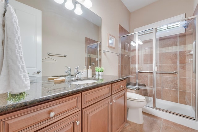 full bath featuring vanity, a stall shower, tile patterned flooring, and toilet