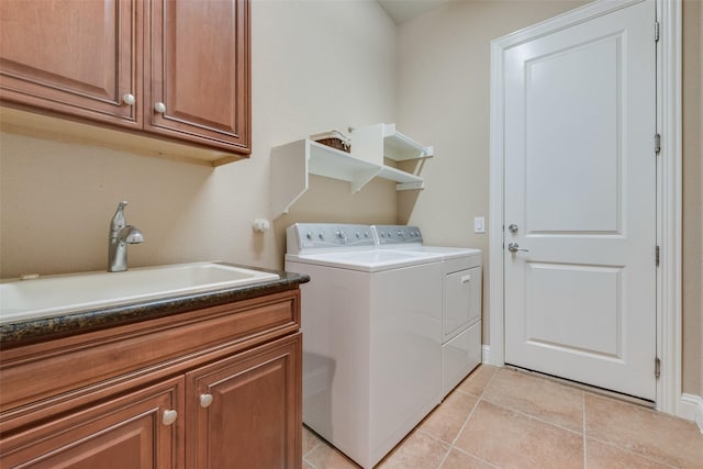 laundry room featuring cabinet space, washer and dryer, a sink, and light tile patterned flooring