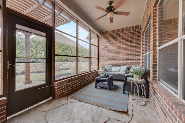 sunroom featuring a ceiling fan