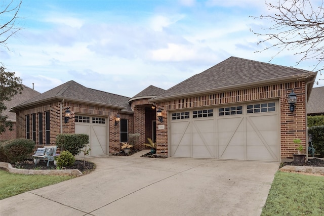 view of front of property featuring a garage and brick siding