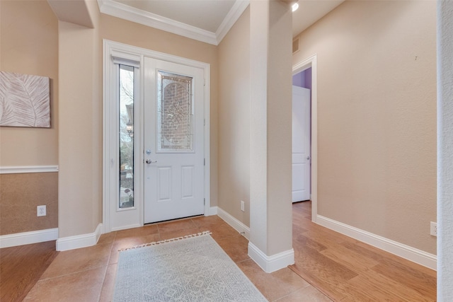 foyer featuring baseboards, tile patterned floors, visible vents, and crown molding