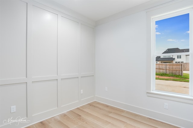 empty room with light wood-style floors and baseboards