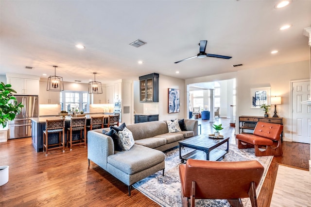 living area featuring recessed lighting, light wood-style floors, visible vents, and ceiling fan