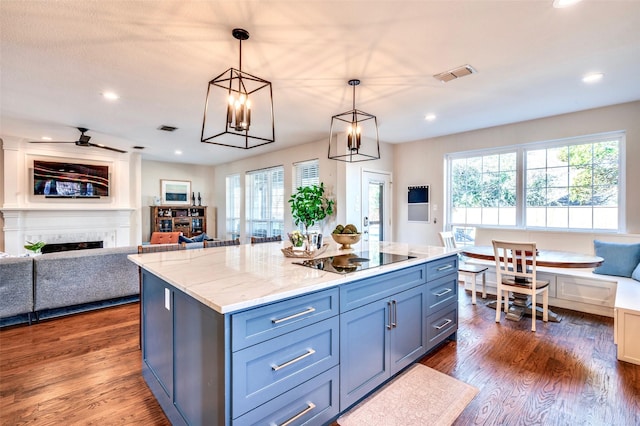 kitchen with dark wood finished floors, open floor plan, a fireplace, and black electric stovetop