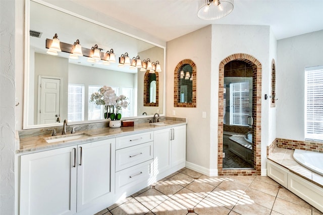 full bath featuring tile patterned floors, a garden tub, a sink, a shower stall, and double vanity