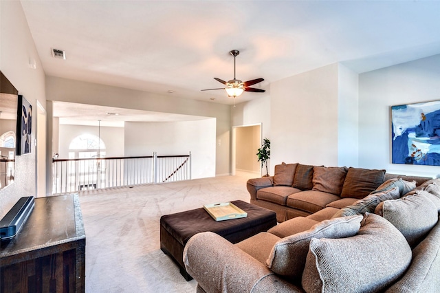 carpeted living room with a ceiling fan and visible vents