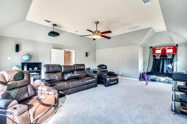 home theater room featuring vaulted ceiling, visible vents, carpet floors, and ceiling fan