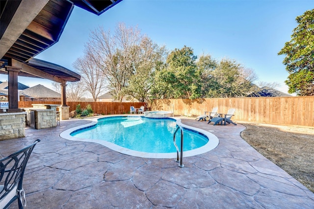 view of swimming pool featuring area for grilling, a fenced backyard, outdoor dry bar, and a patio area