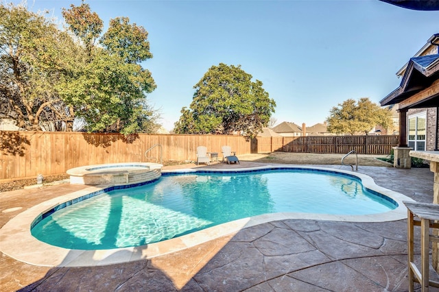 view of pool featuring a pool with connected hot tub, a fenced backyard, and a patio area