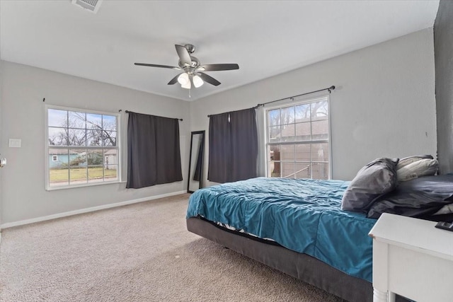 carpeted bedroom featuring visible vents, ceiling fan, and baseboards