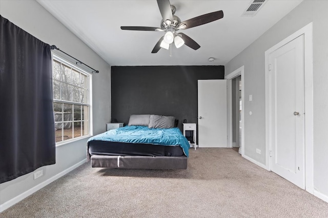 bedroom with carpet, visible vents, ceiling fan, and baseboards